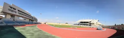 a stadium with a race track in front of a building at Allegra GSP Sport Center in Nicosia