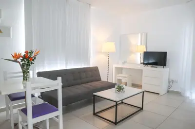 a living room with a couch and a table at Alva Hotel Apartments in Protaras