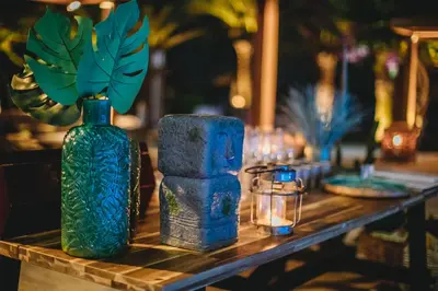a table with blue vases and candles on it at Alion Beach Hotel in Ayia Napa