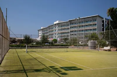 a tennis court with a building in the background at Asterias Beach Hotel in Ayia Napa