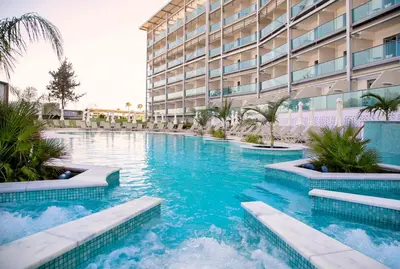 a swimming pool in front of a building at Asterias Beach Hotel in Ayia Napa