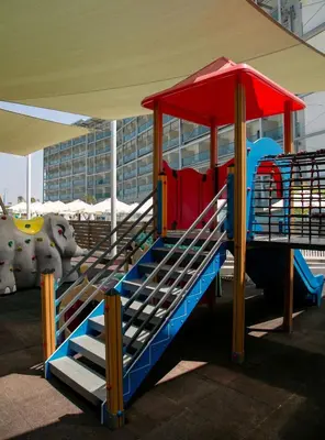 a playground with a slide in a tent at Asterias Beach Hotel in Ayia Napa