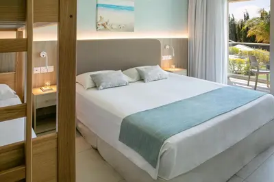 a bedroom with a large bed and a balcony at Asterias Beach Hotel in Ayia Napa