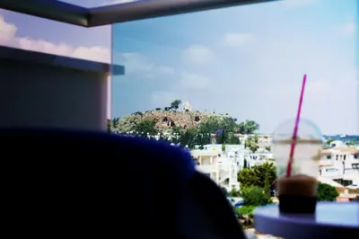 a view of a mountain from a window at Kapetanios Bay Hotel Protaras in Protaras
