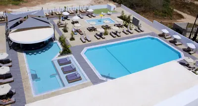 an overhead view of a swimming pool with chaise lounges at Kapetanios Bay Hotel Protaras in Protaras