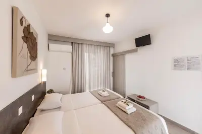 a bedroom with a large bed with two towels on it at Cactus in Larnaka