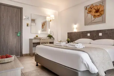 a bedroom with a large bed and a desk at Cactus in Larnaka