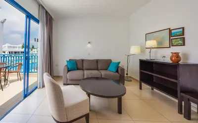 a living room with a couch and a table at MarisMare Apartments in Ayia Napa