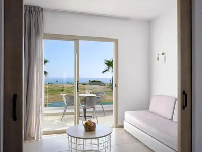 a living room with a couch and a table at Atlantica Panthea Resort in Ayia Napa
