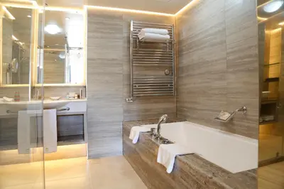 a bathroom with a bath tub and a sink at Columbia Beach Resort in Pissouri
