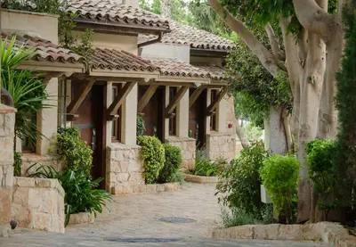 an exterior view of a house with a courtyard at Columbia Beach Resort in Pissouri