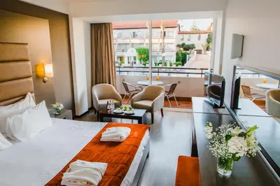a hotel room with a bed and a balcony at Napa Plaza Hotel (Adults Only) in Ayia Napa
