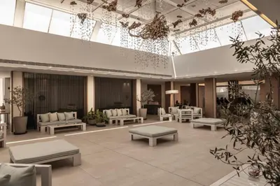 a lobby with couches and tables in a building at Capo Bay Hotel in Protaras