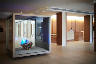 a display case in a building with a painting in it at Capo Bay Hotel in Protaras