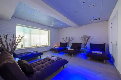 a living room with couches and blue lighting at Golden Bay Beach Hotel in Larnaka