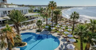an aerial view of a resort with a swimming pool and the beach at Golden Bay Beach Hotel in Larnaka