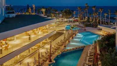 an aerial view of a hotel pool at night at Lordos Beach Hotel & Spa in Larnaka