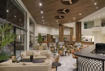 a lobby with couches and tables and a bar at The GrandResort - Leonardo Limited Edition in Limassol