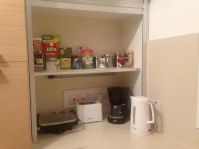 a kitchen with a coffee maker on a shelf at Katikies 22 in Pissouri