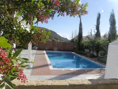 a swimming pool in a yard with trees at Katikies 22 in Pissouri