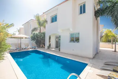 a swimming pool in front of a house at George's Lux Villa in Protaras