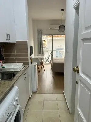 a kitchen with a view of a living room at Harmony Studios in Larnaka