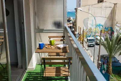 a balcony with two chairs and a table with food on it at Harmony Studios in Larnaka