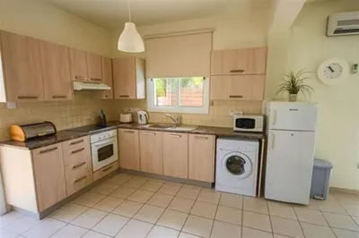 a kitchen with a white refrigerator and a dishwasher at Villa Florie in Protaras