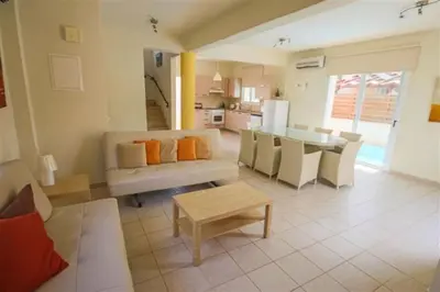 a living room with a couch and a table at Villa Florie in Protaras