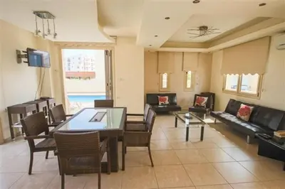 a living room with a table and a couch at Villa Florie in Protaras