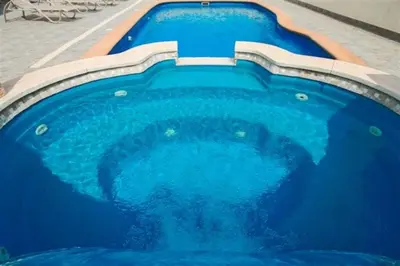 a swimming pool with a person in the water at Villa Florie in Protaras