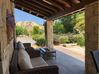 a patio with couches and a table on a patio at Paradise Traditional House in Maroni