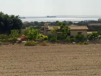 a house in the middle of a field at Paradise Traditional House in Maroni