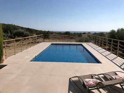 a swimming pool on a patio with chairs around it at Paradise Traditional House in Maroni