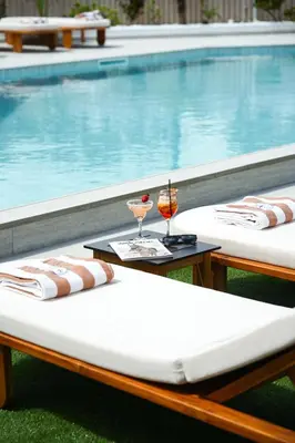 two beds sitting next to a swimming pool at Blue Harbour Boutique in Ayia Napa