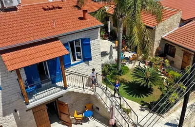 two people standing on a balcony of a house at Niki's House in Limassol