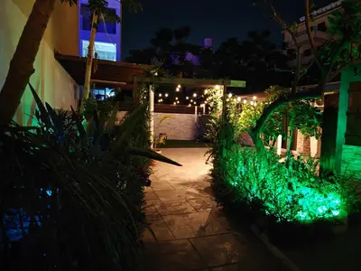 a garden at night with lights on a patio at Mamas Summer House in Larnaka