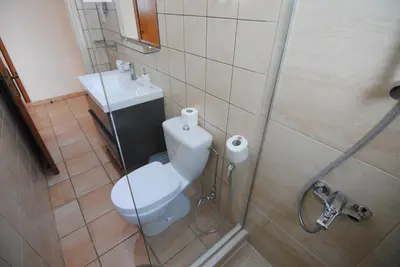 a bathroom with a toilet and a sink at La C Mer in Larnaka