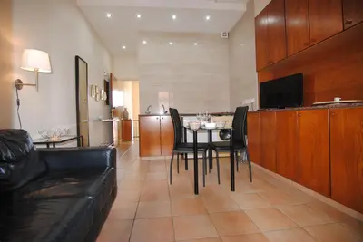 a living room with a table and chairs and a couch at La C Mer in Larnaka