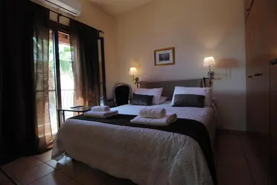 a bedroom with a large bed with towels on it at La C Mer in Larnaka