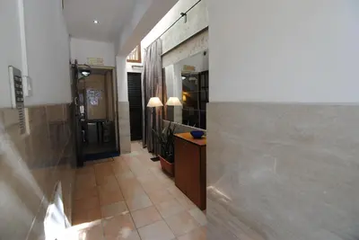 a hallway of a building with a counter and a mirror at La C Mer in Larnaka