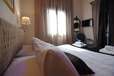 a hotel room with a bed and a mirror at La C Mer in Larnaka