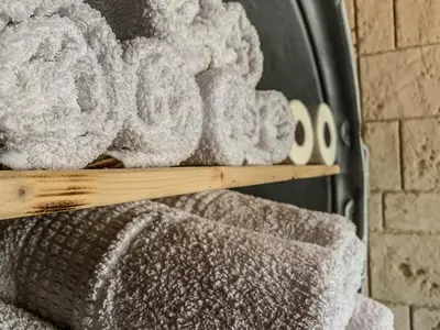 a pile of towels on a shelf in a fireplace at Vasiliou House in Khandria