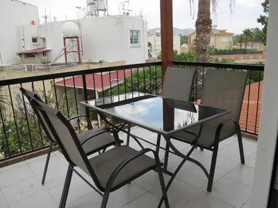 a balcony with a glass table and two chairs at Vergi Apartments in Pyla