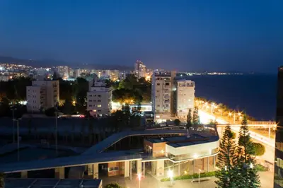 a view of a city at night with lights at Eden Beach Apartment 207 in Limassol