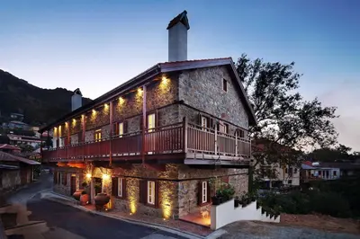 a building with a balcony on the side of it at Aristotelio Boutique Hotel in Pedoulas