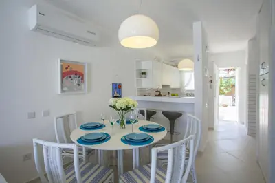 a kitchen and dining room with a table and chairs at Protaras Central Sunrise in Protaras