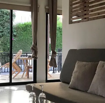 a living room with a couch and a view of a patio at Royal Sunset Studios & Apartments in Limassol