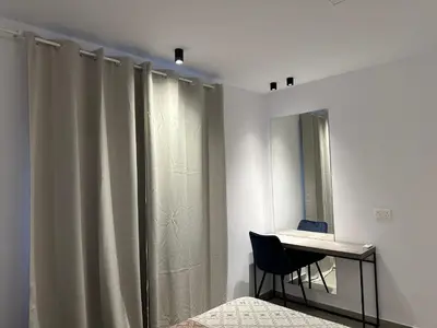 a room with a table and a chair and a mirror at Royal Sunset Studios & Apartments in Limassol