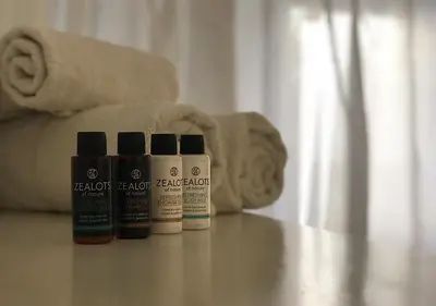 a group of four bottles of hair products sitting on a floor at Royal Sunset Studios & Apartments in Limassol